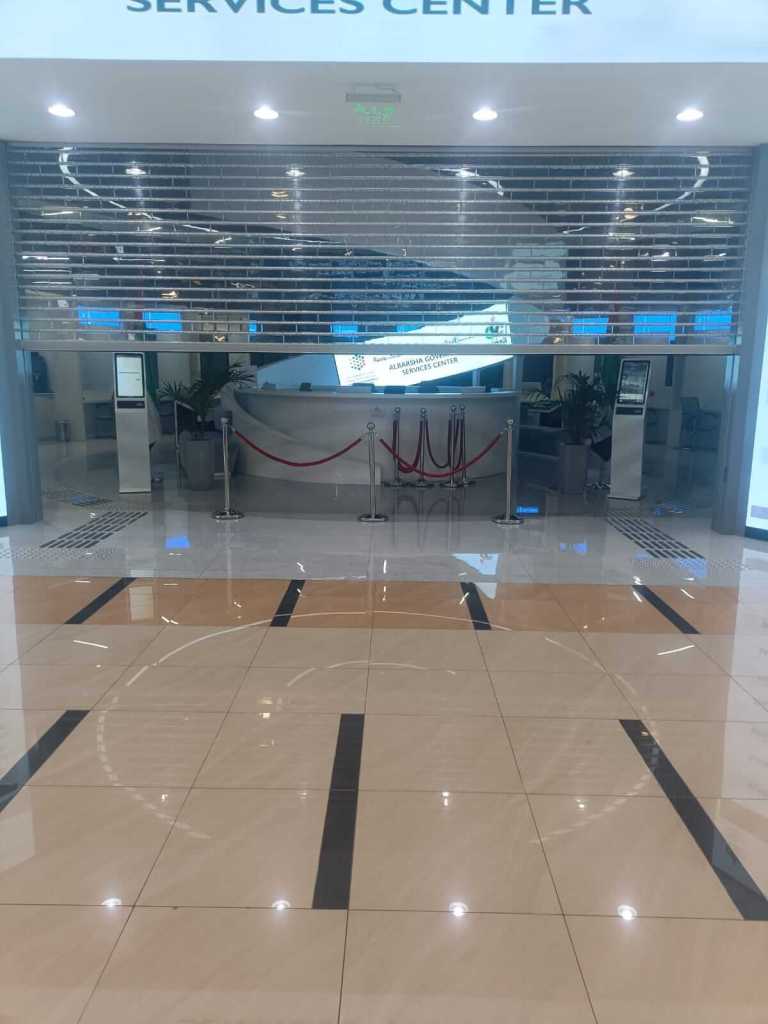 Entrance of the Al Barsha Government Service Center featuring a sleek interior design with a reception area, decorative flooring, and illuminated signage.