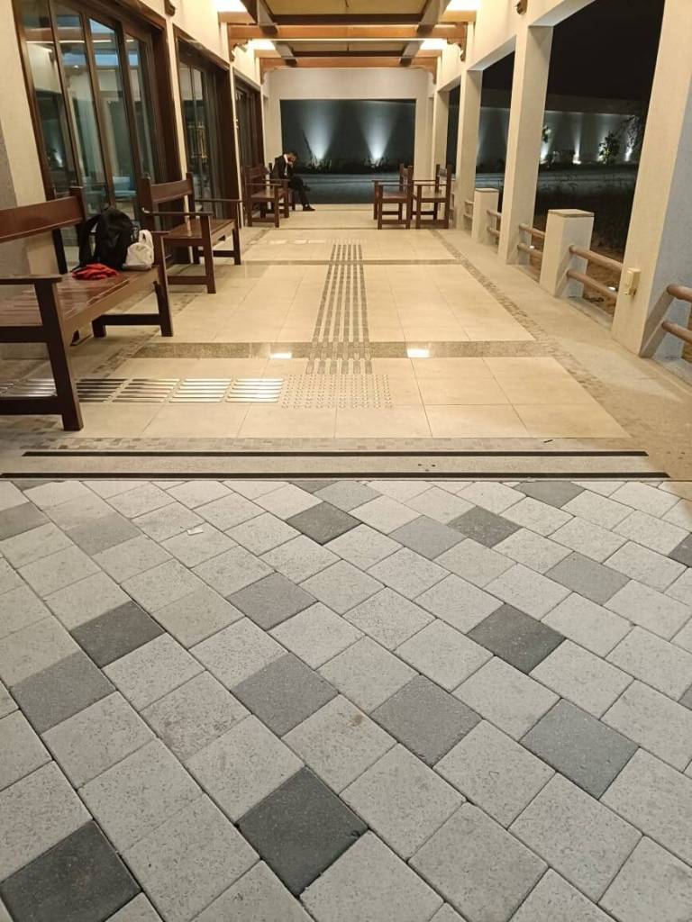 An entrance area at Majlis Al Bahar in Jumeirah featuring tactile pin-type studs and lines embedded in the flooring for improved accessibility.