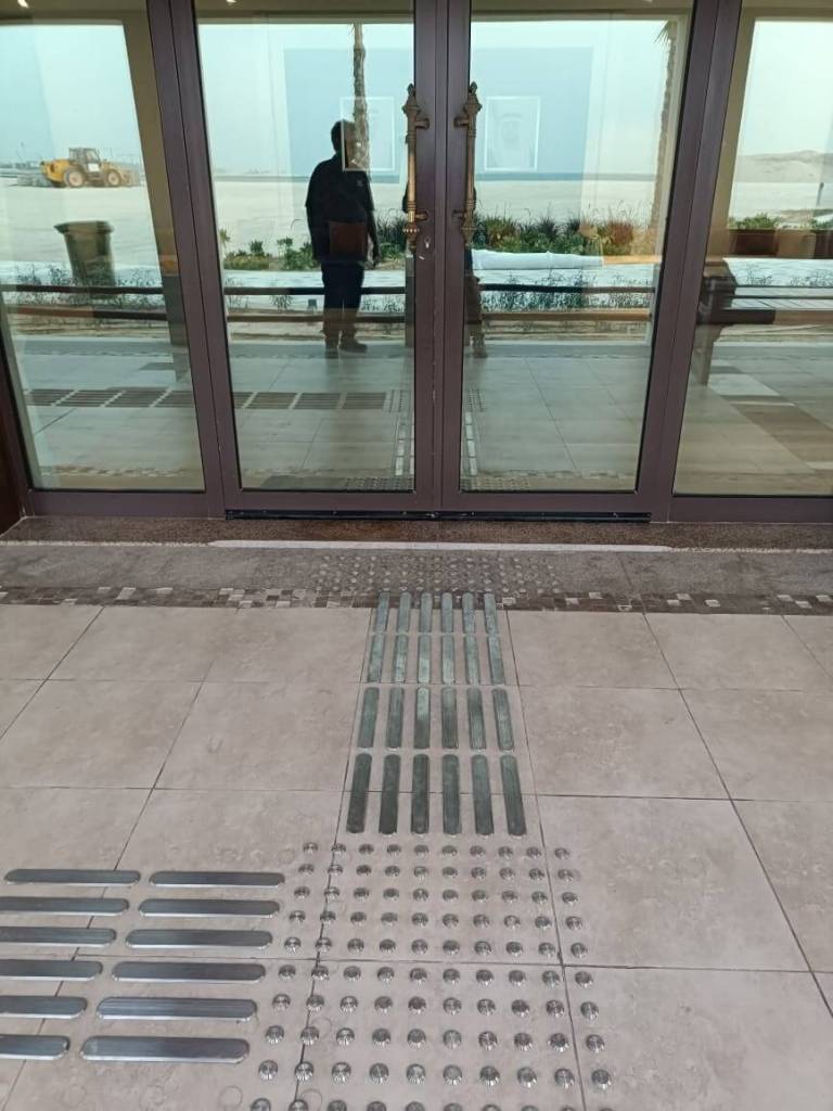 Entrance area featuring stainless steel tactile pin-type studs and lines installed for enhanced accessibility at Majlis Al Bahar, Jumeirah.