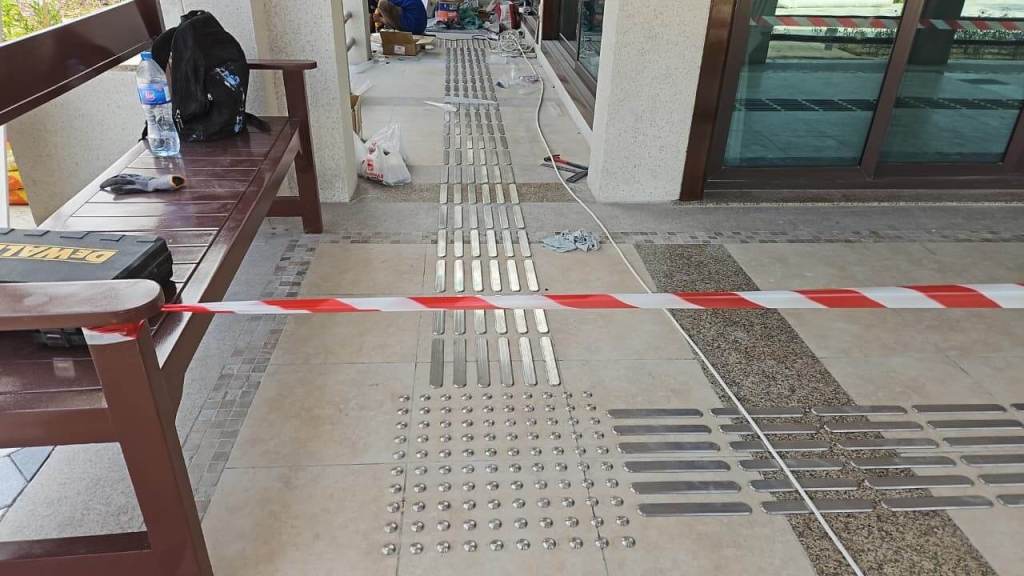 Installation of stainless steel tactile pin-type studs and lines for accessibility at Majlis Al Bahar, Jumeirah.
