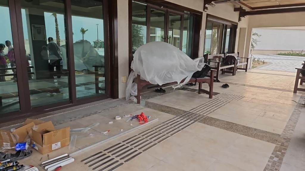 Installation area at Majlis Al Bahar, featuring stainless steel tactile pin-type studs and lines on the floor, surrounded by construction materials and tools.