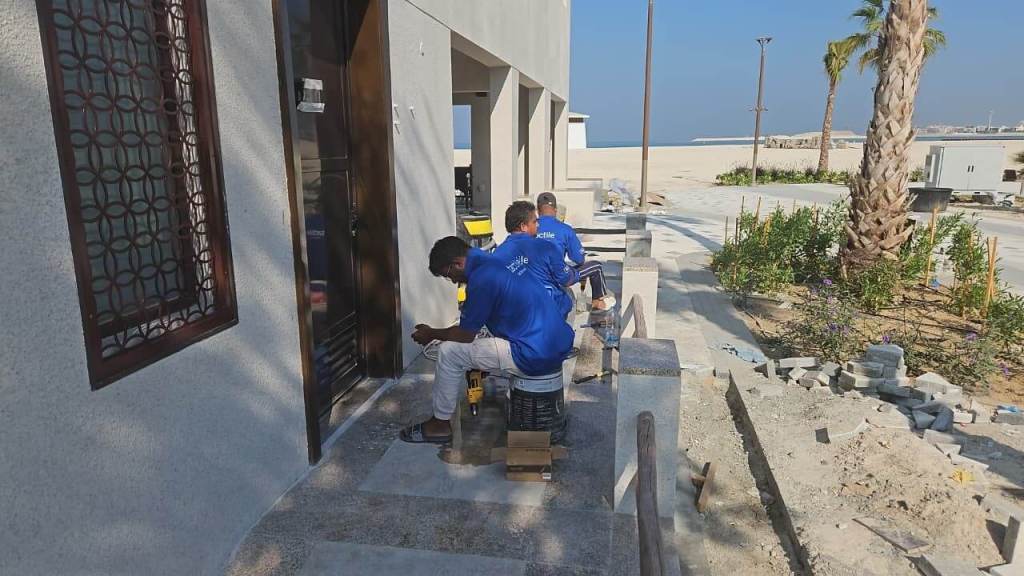 Workers installing tactile indicators outside Majlis Al Bahar in Jumeirah, Dubai.