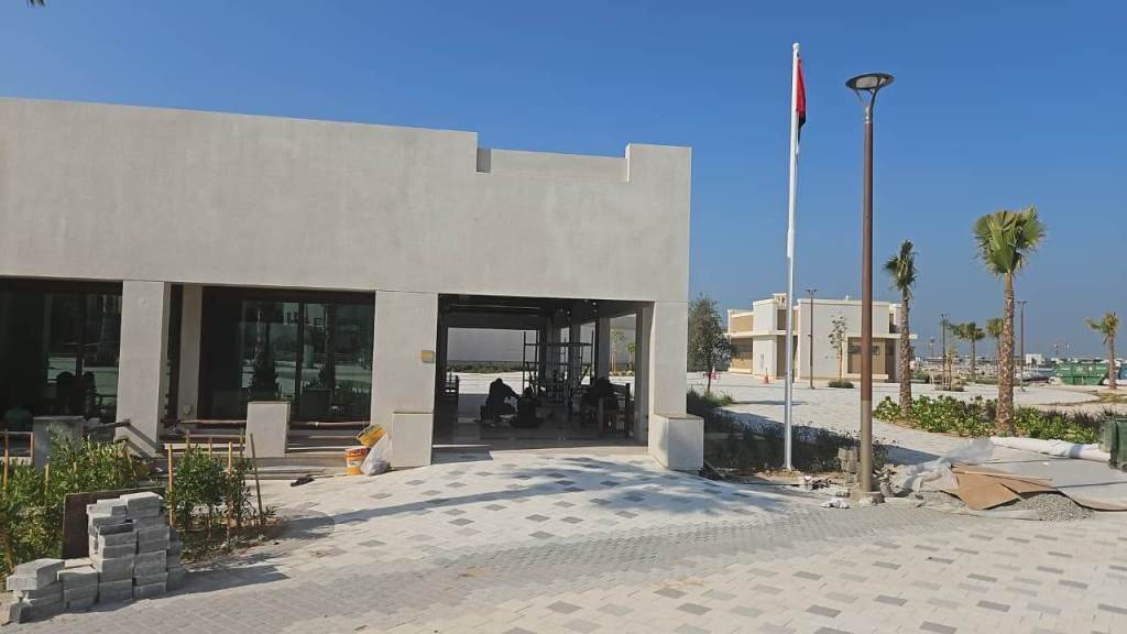 Exterior view of the Prime FM building at Majlis Al Bahar, Jumeirah, showcasing modern architecture, landscaping, and construction elements.